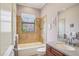 Bathroom with tiled shower-tub combination, vanity, granite countertop, and a decorative window at 9433 San Miguel, Howey In The Hills, FL 34737