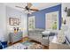 The room has blue walls, hardwood floors, and two windows with white shutters at 9433 San Miguel, Howey In The Hills, FL 34737