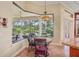Bright breakfast nook with large windows overlooking a beautifully landscaped backyard, perfect for morning coffee at 9433 San Miguel, Howey In The Hills, FL 34737