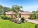 Elegant home featuring a tile roof, paver driveway, and professionally landscaped yard at 9433 San Miguel, Howey In The Hills, FL 34737