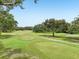 Lush green golf course with manicured fairways, mature trees, and scenic landscaping at 9433 San Miguel, Howey In The Hills, FL 34737