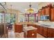 Gourmet kitchen featuring stainless steel appliances, granite countertops, custom cabinets, and an adjacent breakfast nook at 9433 San Miguel, Howey In The Hills, FL 34737