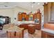 Spacious kitchen with granite countertops, custom wood cabinetry, stainless steel appliances, and center island at 9433 San Miguel, Howey In The Hills, FL 34737