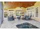 A covered outdoor lanai featuring brick pavers, seating areas, a pool and wood ceilings at 9433 San Miguel, Howey In The Hills, FL 34737