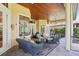 Screened lanai with brick pavers, wicker furniture, and wood-paneled ceiling at 9433 San Miguel, Howey In The Hills, FL 34737