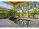 Screened in brick patio and water feature with an open view of the beautiful landscape at 9433 San Miguel, Howey In The Hills, FL 34737