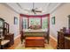 Serene main bedroom with tray ceilings, bay windows, and a luxurious four-poster bed for ultimate relaxation at 9433 San Miguel, Howey In The Hills, FL 34737