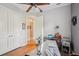This is a home office with wood floors, white doors, a metal desk, and neutral walls at 9433 San Miguel, Howey In The Hills, FL 34737