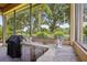 This outdoor kitchen on a screened lanai has a built-in grill, sink, and granite countertops at 9433 San Miguel, Howey In The Hills, FL 34737