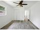 Well-lit bedroom with ceiling fan, wood-look floors and closet at 1134 Cr 464, Lake Panasoffkee, FL 33538