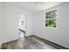 Bedroom with neutral walls, grey flooring and a window to the exterior at 1134 Cr 464, Lake Panasoffkee, FL 33538
