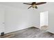 Bedroom boasts gray flooring, neutral paint, and a ceiling fan at 1134 Cr 464, Lake Panasoffkee, FL 33538