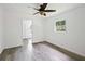 Bedroom features neutral walls, a ceiling fan and light gray flooring at 1134 Cr 464, Lake Panasoffkee, FL 33538
