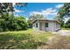 Exterior of home featuring a well-maintained lawn, and serene views at 1134 Cr 464, Lake Panasoffkee, FL 33538