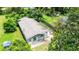 A charming single-story home with a classic gray roof, complemented by green lawns and trees at 1134 Cr 464, Lake Panasoffkee, FL 33538