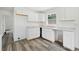 Bright kitchen with white cabinets, stylish countertops, and wood-look flooring at 1134 Cr 464, Lake Panasoffkee, FL 33538