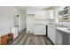 Bright kitchen with white cabinets, light countertops, and new gray flooring at 1134 Cr 464, Lake Panasoffkee, FL 33538
