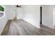Open living room with wood-look flooring and entry to other rooms at 1134 Cr 464, Lake Panasoffkee, FL 33538