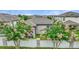 Charming backyard view featuring lush pink crape myrtle trees lining a pristine fence at 120 Citrus Isle St, Davenport, FL 33837