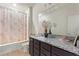Bathroom featuring granite countertop, dark wood cabinetry, and tub-shower combo at 120 Citrus Isle St, Davenport, FL 33837