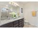 The bathroom is equipped with double sinks, granite counters, and an enclosed shower for a spa-like experience at 120 Citrus Isle St, Davenport, FL 33837