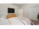 Comfortable bedroom with light walls, closet, TV, and a dresser for storage and decor at 120 Citrus Isle St, Davenport, FL 33837