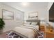 Cozy bedroom featuring a tufted headboard, two side tables with lamps, modern decor and lots of natural light at 120 Citrus Isle St, Davenport, FL 33837
