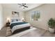 Bright bedroom with large window, ceiling fan, stylish decor and a comfortable bed perfect for relaxation at 120 Citrus Isle St, Davenport, FL 33837