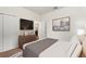 Bedroom with TV, storage and decor, neutral colors, and an open doorway to another room at 120 Citrus Isle St, Davenport, FL 33837