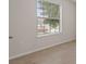 Empty room with neutral walls, light-colored tile floor, and a window at 120 Citrus Isle St, Davenport, FL 33837
