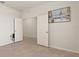 Empty room featuring neutral walls, light-colored flooring, and double doors at 120 Citrus Isle St, Davenport, FL 33837