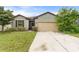 Charming single-story home featuring a well-maintained lawn and a neutral two-car garage at 120 Citrus Isle St, Davenport, FL 33837