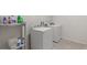 Laundry room featuring a washer and dryer with storage shelving for supplies at 120 Citrus Isle St, Davenport, FL 33837