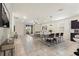 The spacious open concept living and dining room area is flooded with natural light from the glass sliding doors at 120 Citrus Isle St, Davenport, FL 33837