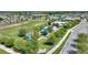 This aerial shot displays a community playground area with a fenced-in playground, picnic area, and soccer field at 120 Citrus Isle St, Davenport, FL 33837