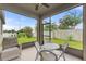 View from inside the screened in patio featuring a table, chairs, and upholstered chair at 120 Citrus Isle St, Davenport, FL 33837