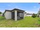 View of the covered screened porch featuring patio furniture and ceiling fan at 120 Citrus Isle St, Davenport, FL 33837