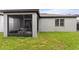 View of the covered screened porch featuring patio furniture at 120 Citrus Isle St, Davenport, FL 33837