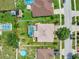 Aerial view of home with screened pool, spacious yard, and surrounding residential area at 1216 Cheshire St, Groveland, FL 34736