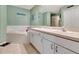 Bathroom with double sinks, a bathtub and a shower at 1216 Cheshire St, Groveland, FL 34736