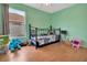 Well-lit bedroom with hardwood floors, a window, and playful decor at 1216 Cheshire St, Groveland, FL 34736