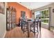 Stylish dining room featuring wood-look floors, a modern chandelier, and ample natural light at 1216 Cheshire St, Groveland, FL 34736