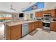 Functional kitchen featuring stainless steel appliances, light wood cabinets, and an open design to living area at 1216 Cheshire St, Groveland, FL 34736