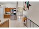 Spacious kitchen with stainless steel refrigerator opening to the home's entrance at 1216 Cheshire St, Groveland, FL 34736