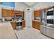 Well-lit kitchen featuring stainless steel appliances, wood cabinets, and neutral countertops at 1216 Cheshire St, Groveland, FL 34736