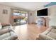Cozy living room with sliding glass doors to the patio and a decorative fireplace at 1216 Cheshire St, Groveland, FL 34736