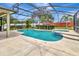 Beautiful screened-in pool and spa with tiled accents and spacious deck at 1216 Cheshire St, Groveland, FL 34736