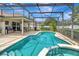 Inviting screened-in pool with a connected spa and patio with ample space for entertaining at 1216 Cheshire St, Groveland, FL 34736