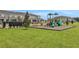 Community lawn with play structure provides a fun and engaging outdoor area at 13108 Serene Glade Rd, Winter Garden, FL 34787