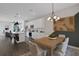 Open-concept dining room and kitchen with modern furnishings and a striking light fixture at 13108 Serene Glade Rd, Winter Garden, FL 34787